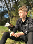 Load image into Gallery viewer, Boy wearing lightweight black quick dry polo shirt with his hunting dog

